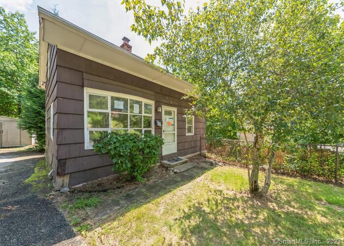 a view of house with backyard and garden