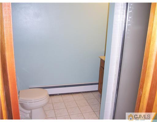 18 Weldon Road Edison, NJ 08817 - Photo 13 of 18 a bathroom with a toilet and a shower curtain