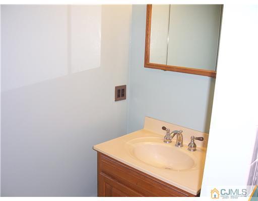18 Weldon Road Edison, NJ 08817 - Photo 14 of 18 a bathroom with a sink and a mirror