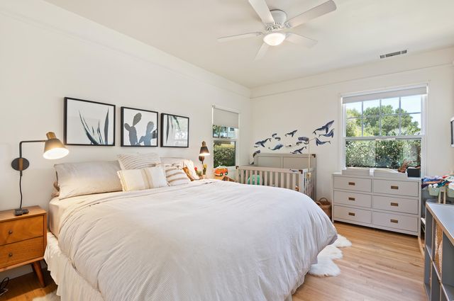 a bedroom with a bed and a large window