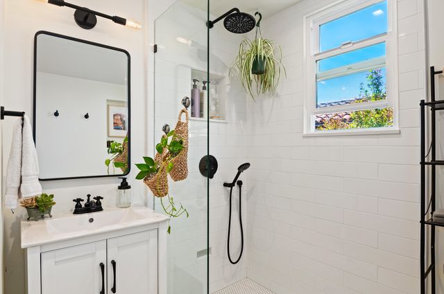 a bathroom with a shower sink and mirror