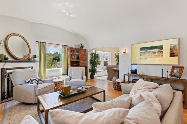 a living room with furniture a large window and a flat screen tv