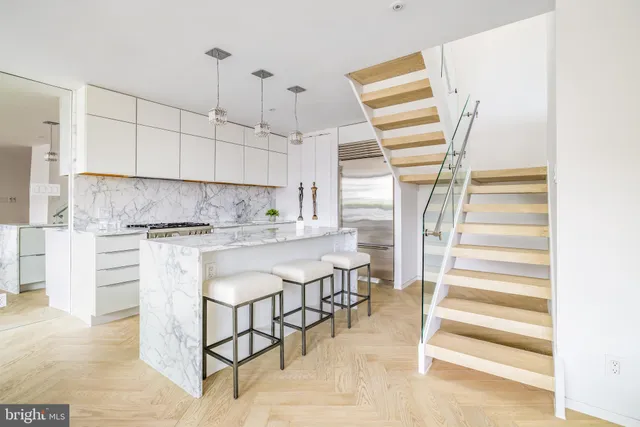 a kitchen with stainless steel appliances granite countertop a sink and a refrigerator