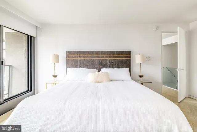 a bedroom with a bed and a view of closet