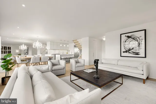 a living room with furniture a rug and white walls