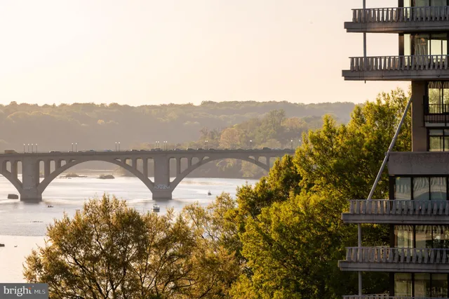 a bathroom with a granite countertop sink mirror toilet and bathtub