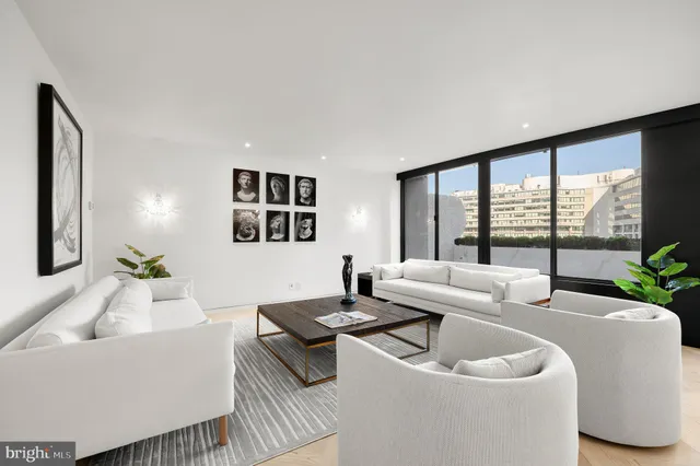 a living room with furniture and large windows