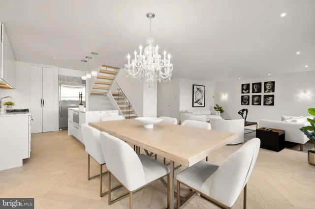 a view of a dining room with furniture and chandelier