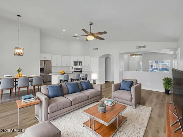 a living room with furniture ceiling fan and a rug