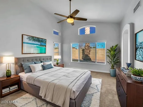 a bedroom with a bed and a potted plant