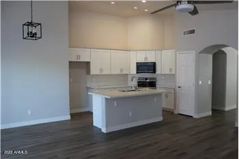 a kitchen with a refrigerator and a stove top oven