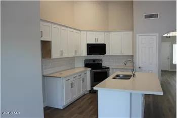 a kitchen with a sink a stove and a microwave