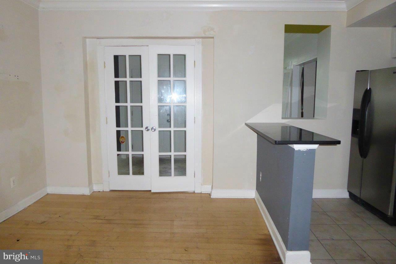 1246 Queen Street Northeast, Unit 3 Washington, DC 20002 - Photo 12 of 14 a view of an empty room with a kitchen