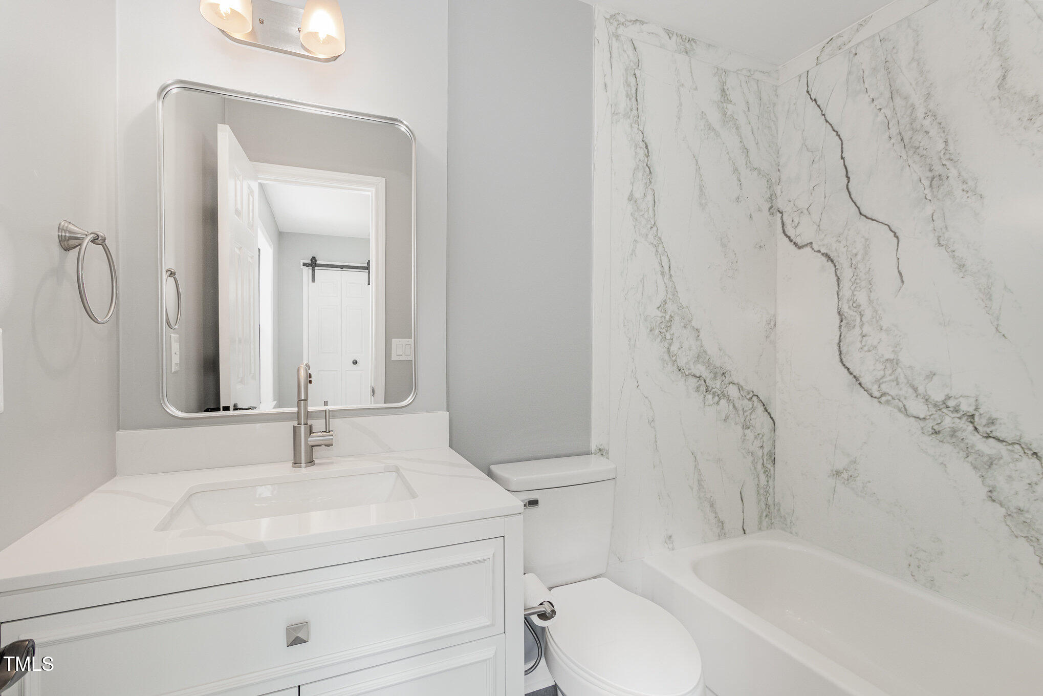 7708 Falcon Rest Circle Raleigh, NC 27615 - Photo 18 of 23 Gorgeous surround for tub/shower combo, vanity with storage.