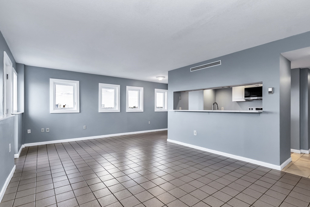 165 Cottage Street, Unit 711 Chelsea, MA 02150 - Photo 11 of 39 a view of an empty room with window and wooden floor