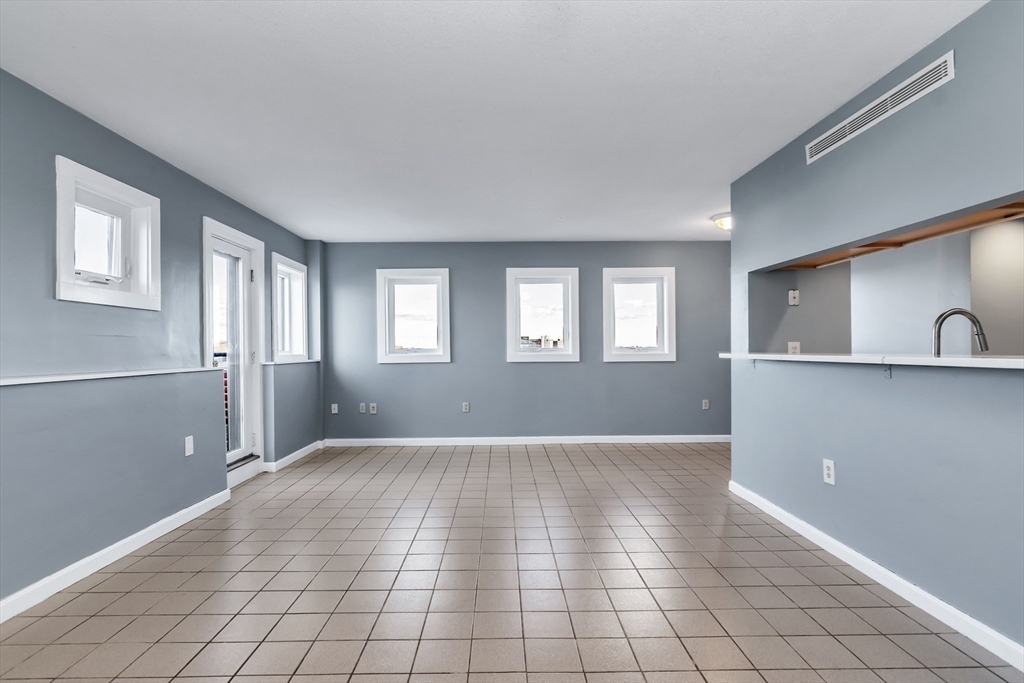 165 Cottage Street, Unit 711 Chelsea, MA 02150 - Photo 16 of 39 a view of an empty room with window and wooden floor