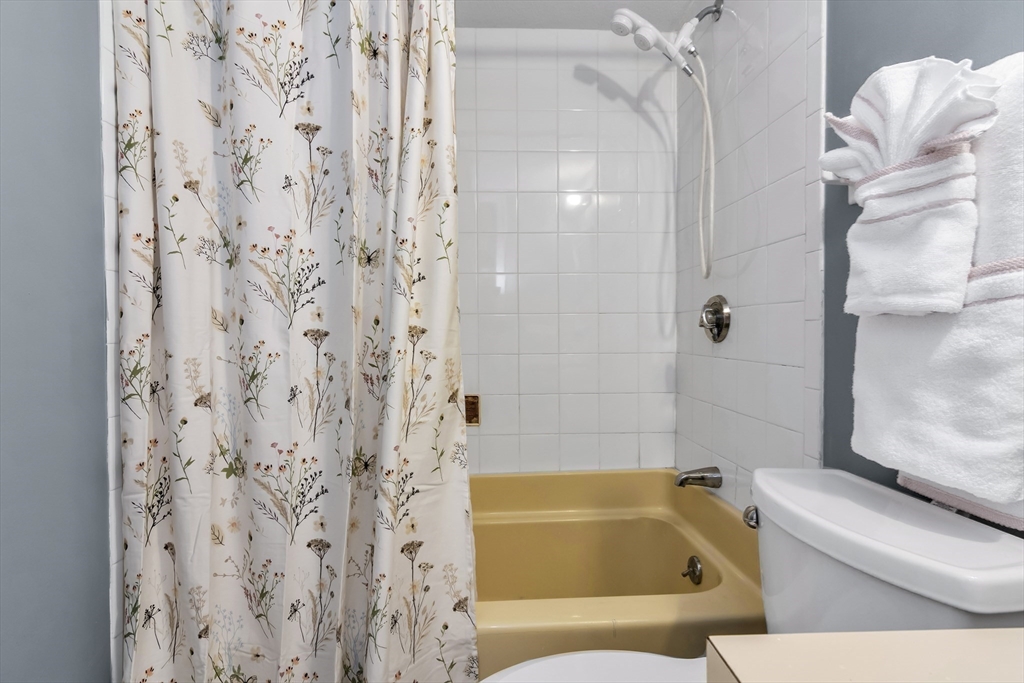 165 Cottage Street, Unit 711 Chelsea, MA 02150 - Photo 18 of 39 a bathroom with a tub and shower