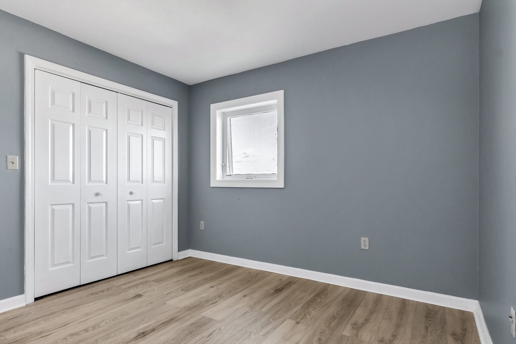 165 Cottage Street, Unit 711 Chelsea, MA 02150 - Photo 21 of 39 an empty room with wooden floor and windows