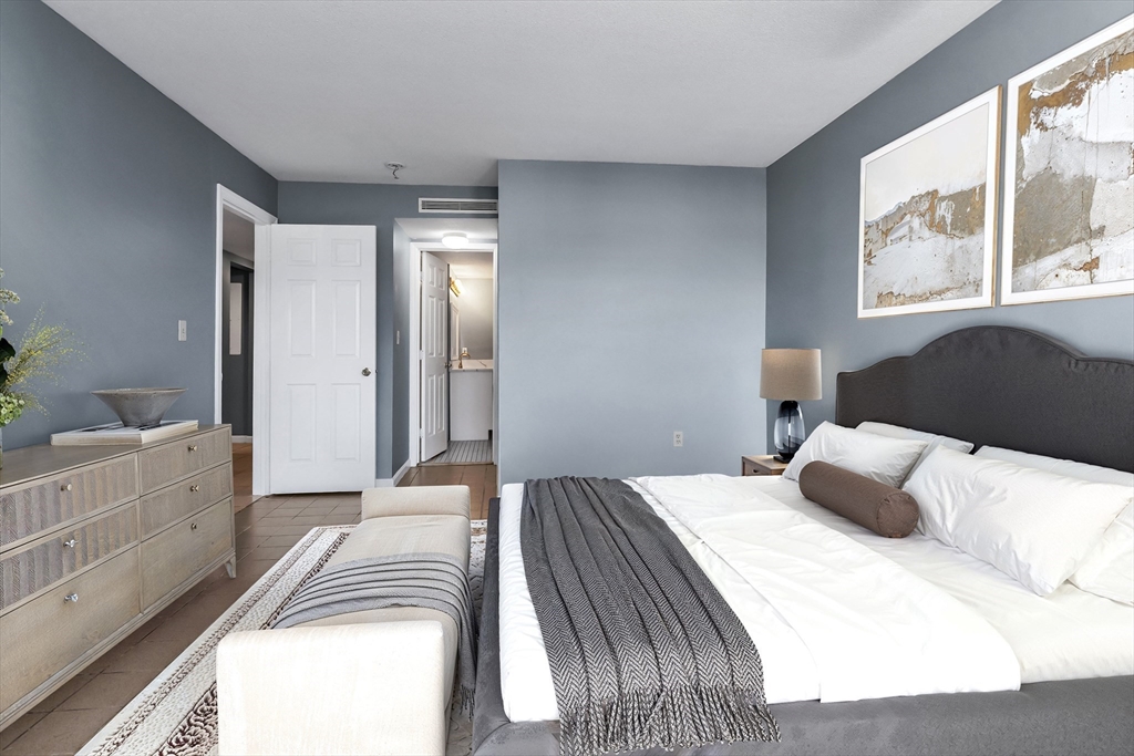 165 Cottage Street, Unit 711 Chelsea, MA 02150 - Photo 25 of 39 a bedroom with a bed and a large window