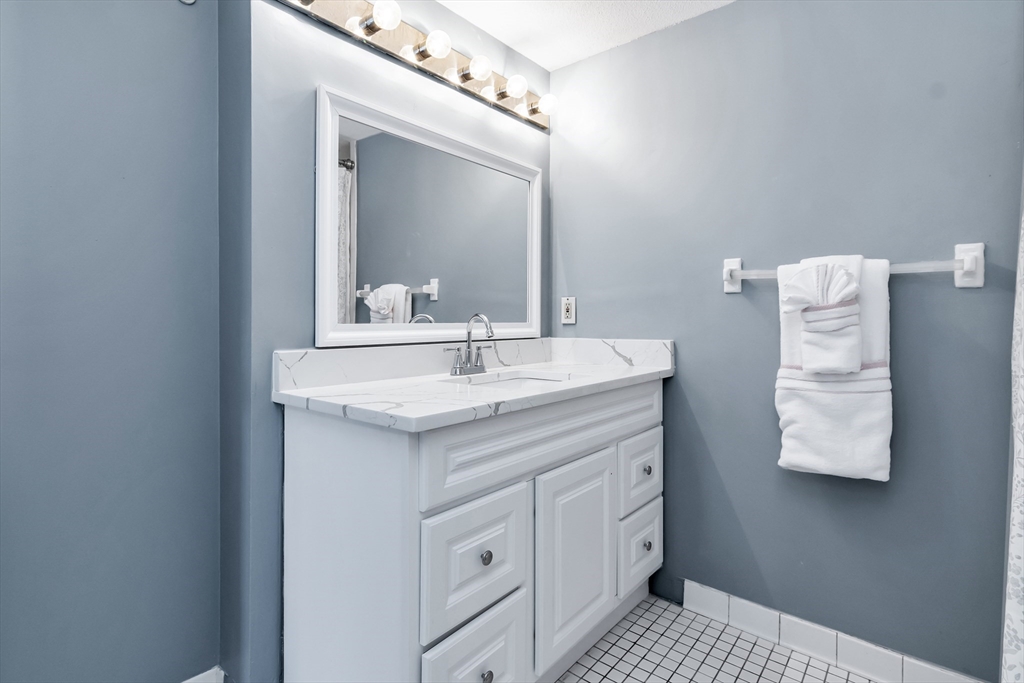 165 Cottage Street, Unit 711 Chelsea, MA 02150 - Photo 28 of 39 a bathroom with a sink and a mirror