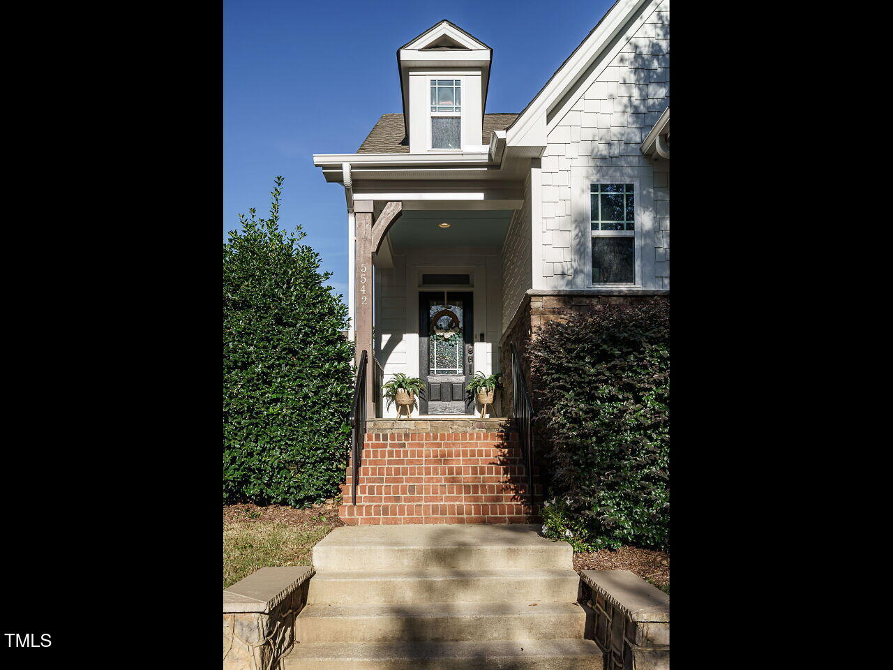 5542 Wade Park Boulevard Raleigh, NC 27607 - Photo 3 of 32 a front view of a house with a yard