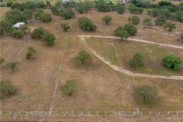 an aerial view of a house with a yard