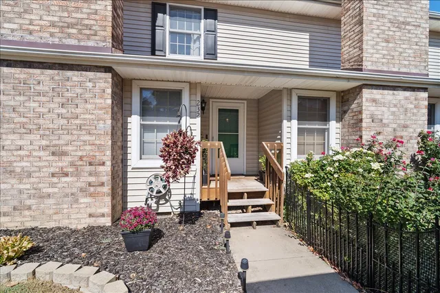 a view of a house with potted plants