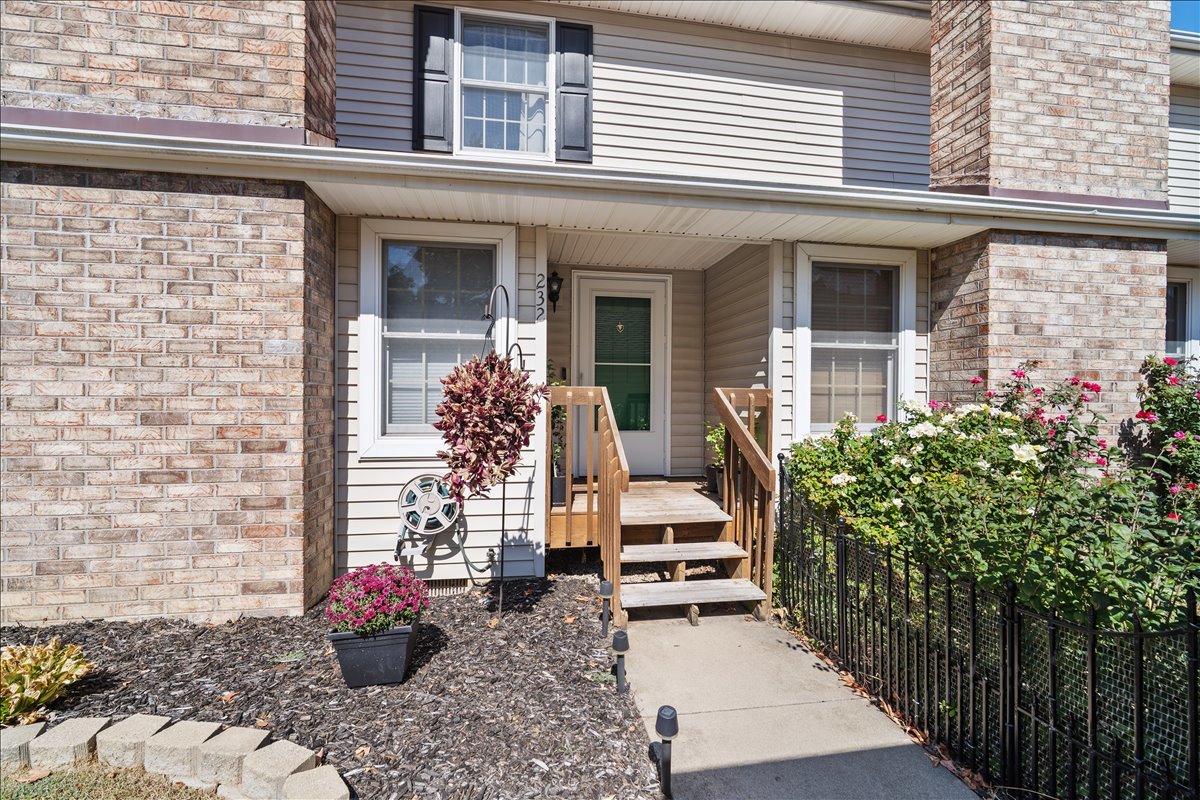 a view of a house with potted plants