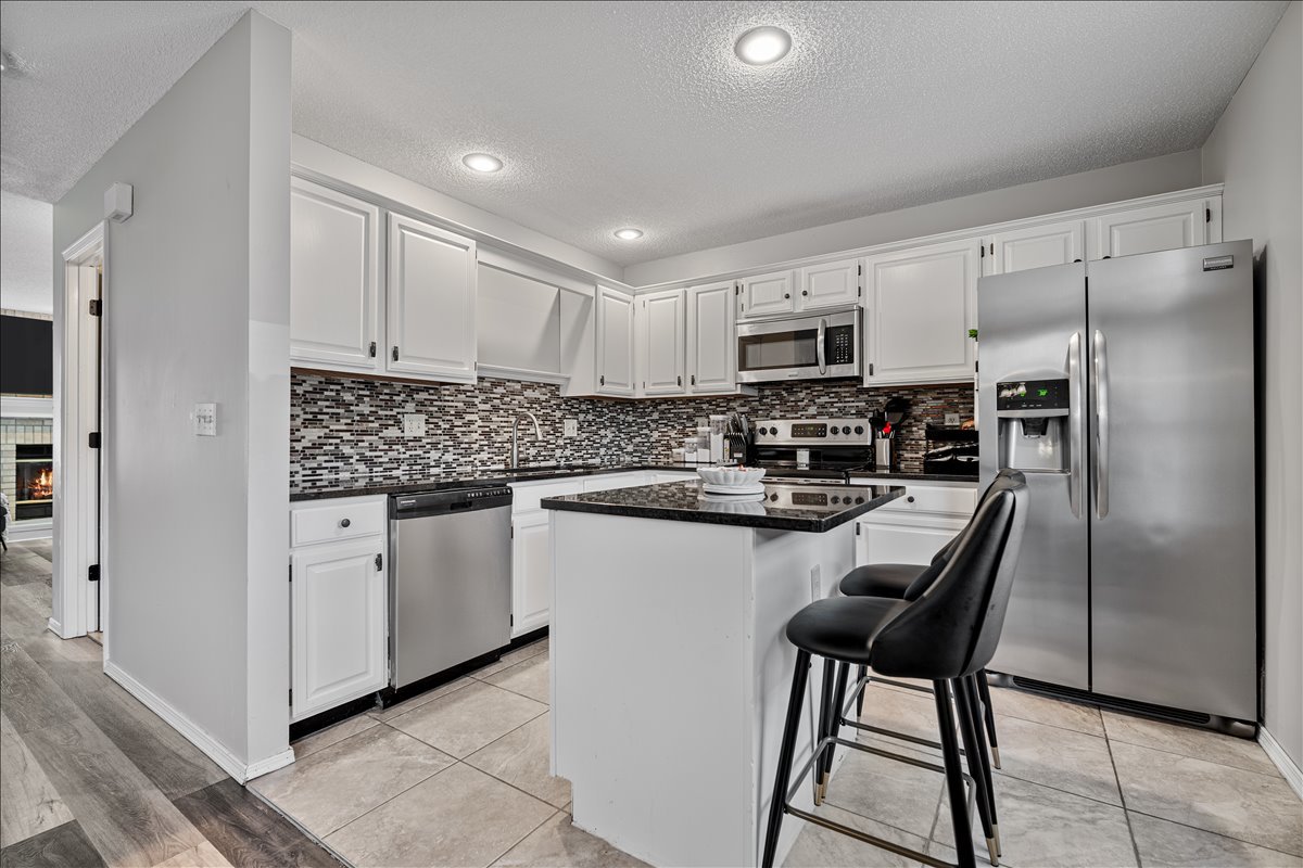 903 North Linden Street, Unit 232 Normal, IL 61761 - Photo 11 of 25 a kitchen with stainless steel appliances granite countertop a refrigerator stove microwave and sink