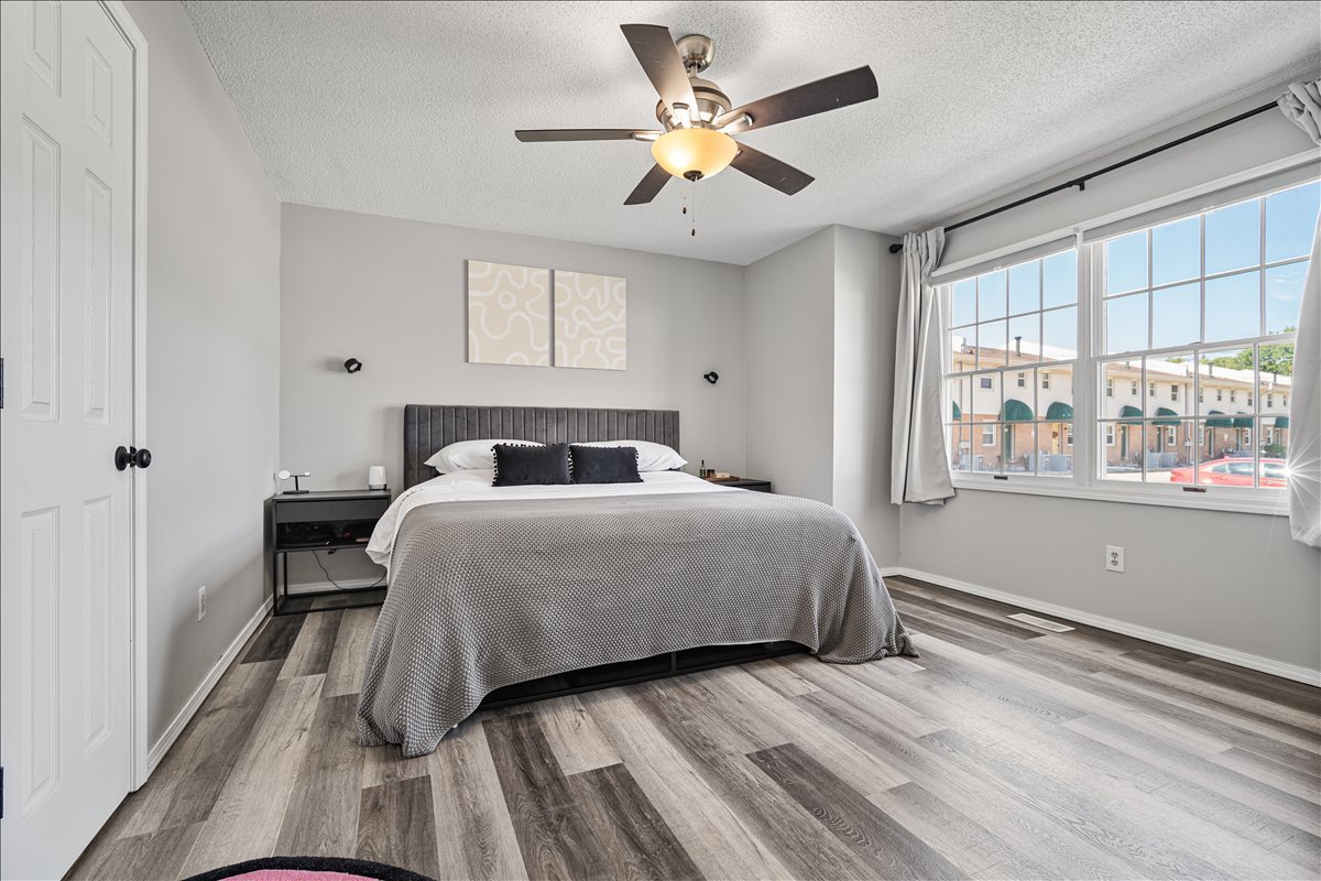 903 North Linden Street, Unit 232 Normal, IL 61761 - Photo 16 of 25 a bedroom with a bed and a large window with wooden floor
