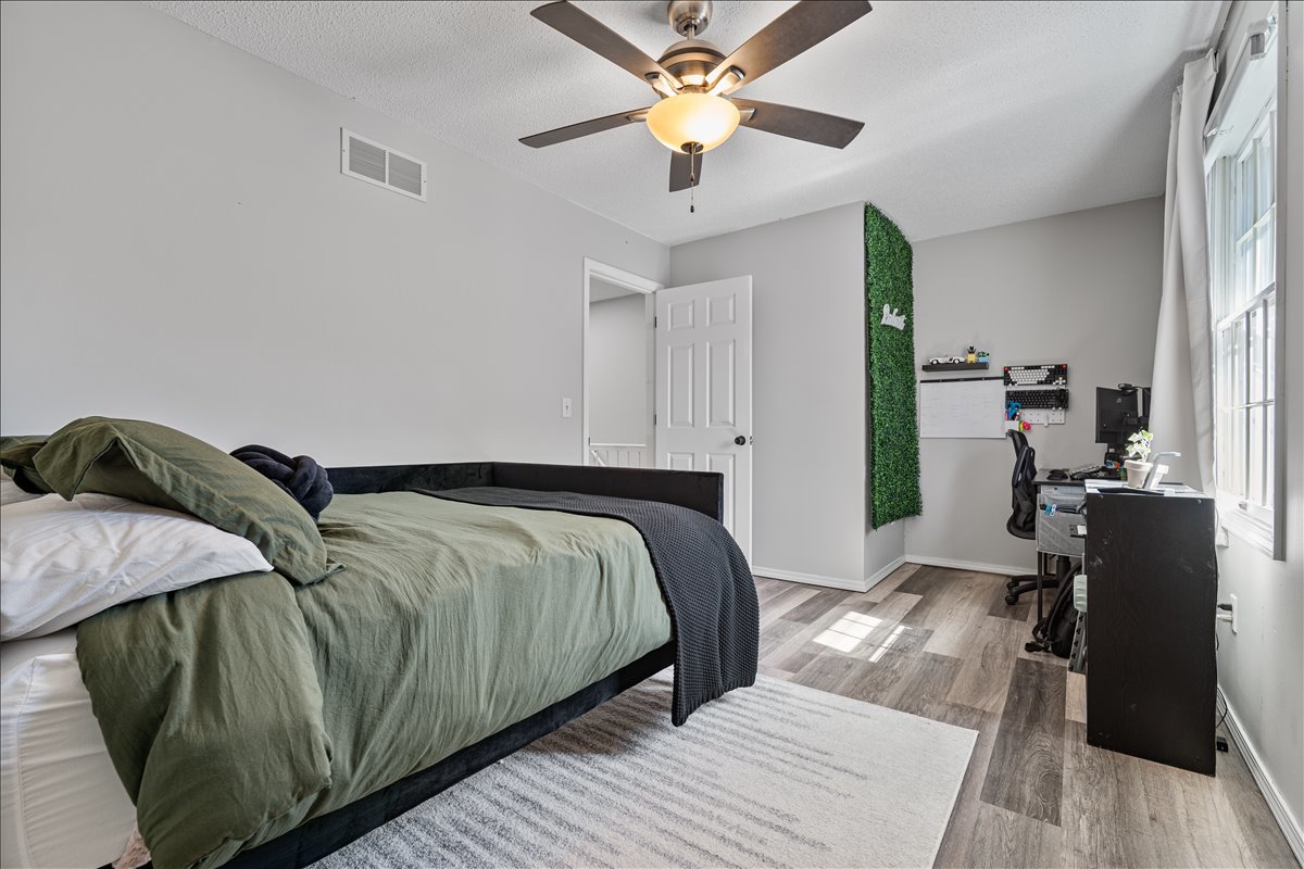903 North Linden Street, Unit 232 Normal, IL 61761 - Photo 19 of 25 a bedroom with a bed and wooden floor