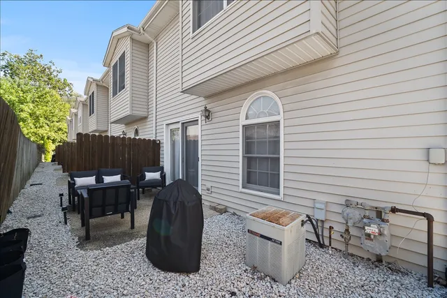 a view of a chairs and table in the backyard