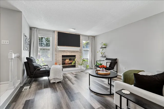 a living room with furniture fireplace and window