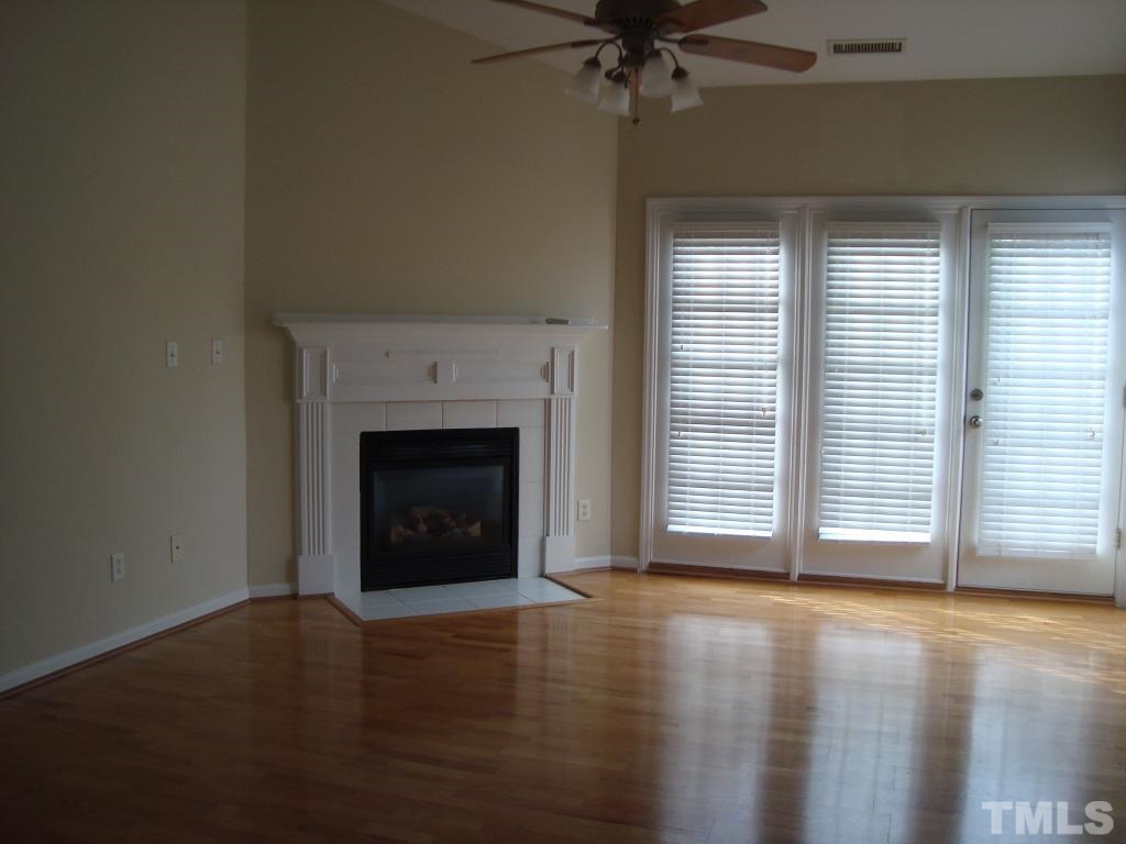 11035 Louson Place Raleigh, NC 27614 - Photo 13 of 24 More wood flooring and ceiling fan in the living room!