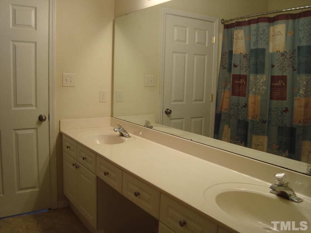 11035 Louson Place Raleigh, NC 27614 - Photo 16 of 24 The master bath has a large vanity with 2 sinks and tile floors!