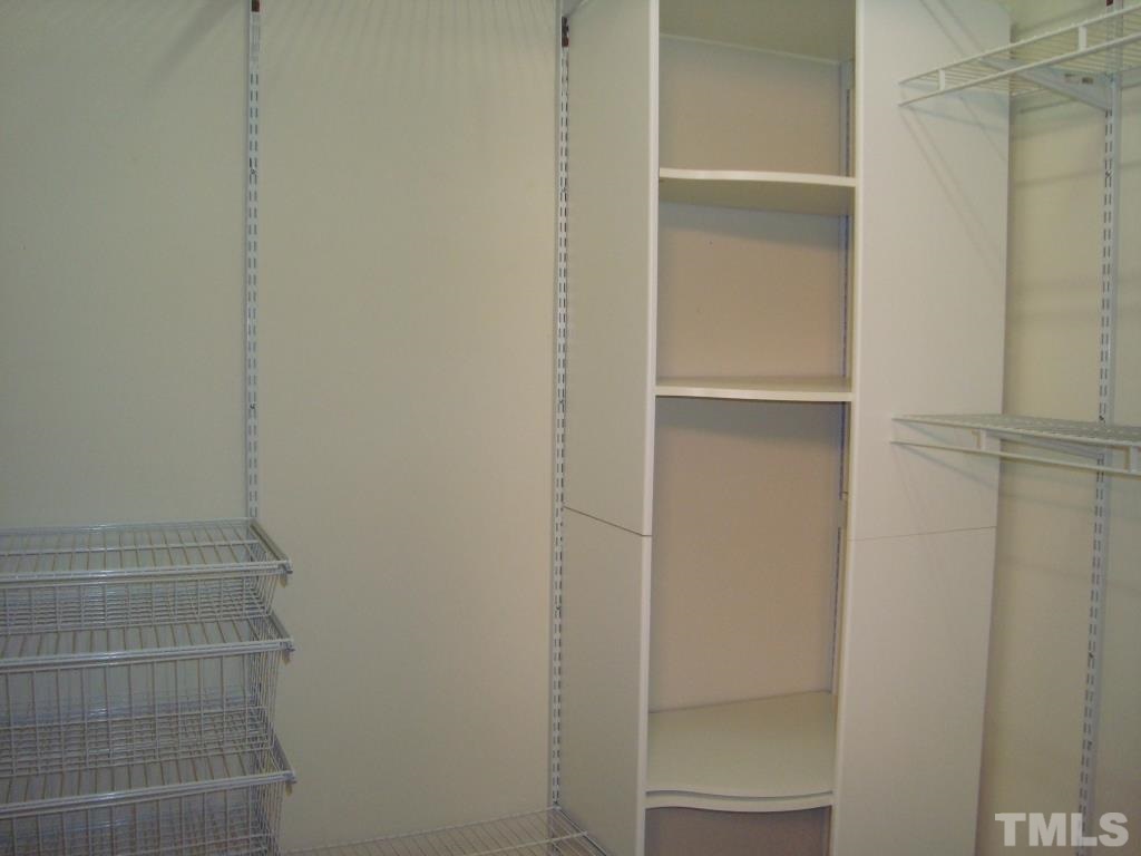11035 Louson Place Raleigh, NC 27614 - Photo 17 of 24 This walk in closet in the master has built in shelves to help you organize everything!