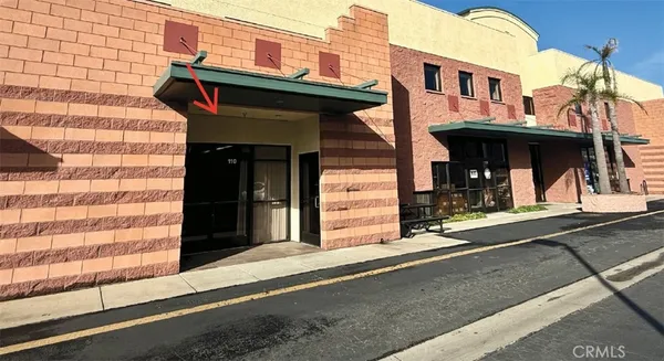 a view of a building with car parked