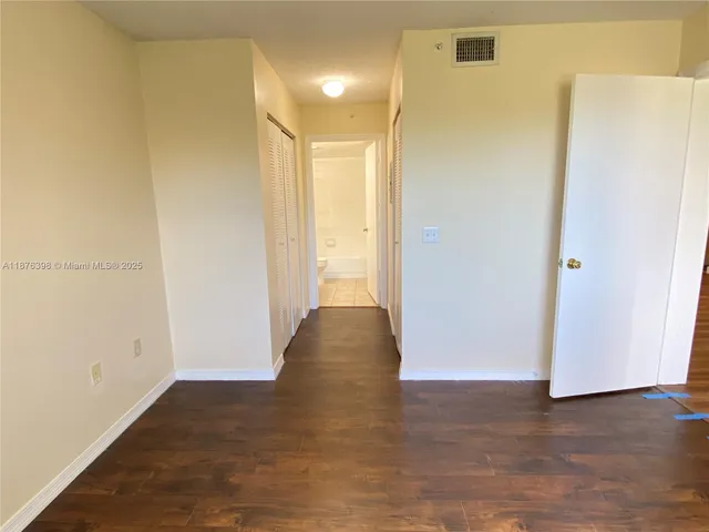 a front view of a house with a yard and potted plants