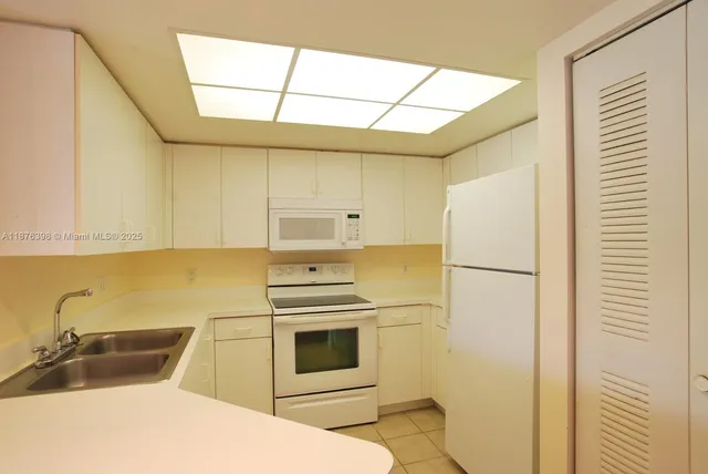 a kitchen with a sink and a refrigerator