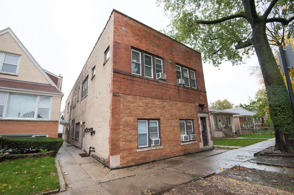 a brick house with a large windows