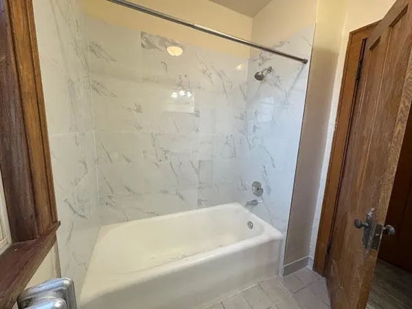 a bathroom with a bathtub and shower