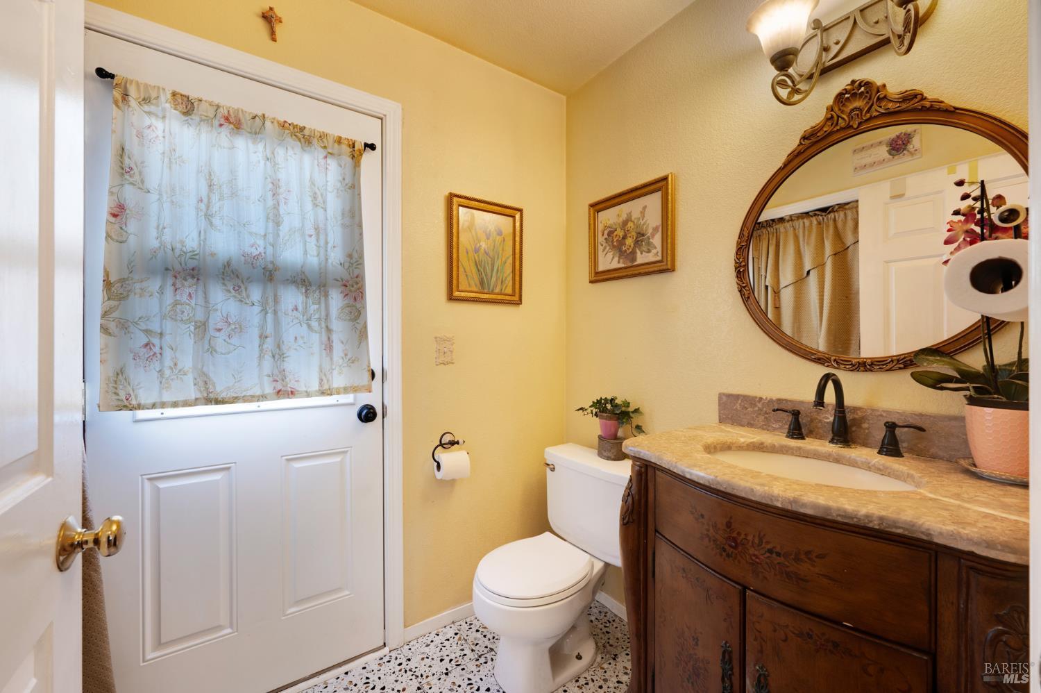 1905 Belair Way Santa Rosa, CA 95403 - Photo 12 of 27 a bathroom with a granite countertop toilet sink and mirror