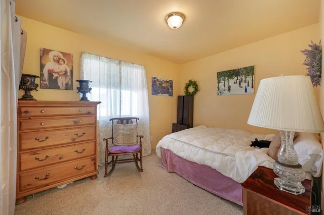 a bedroom with a bed and a dresser