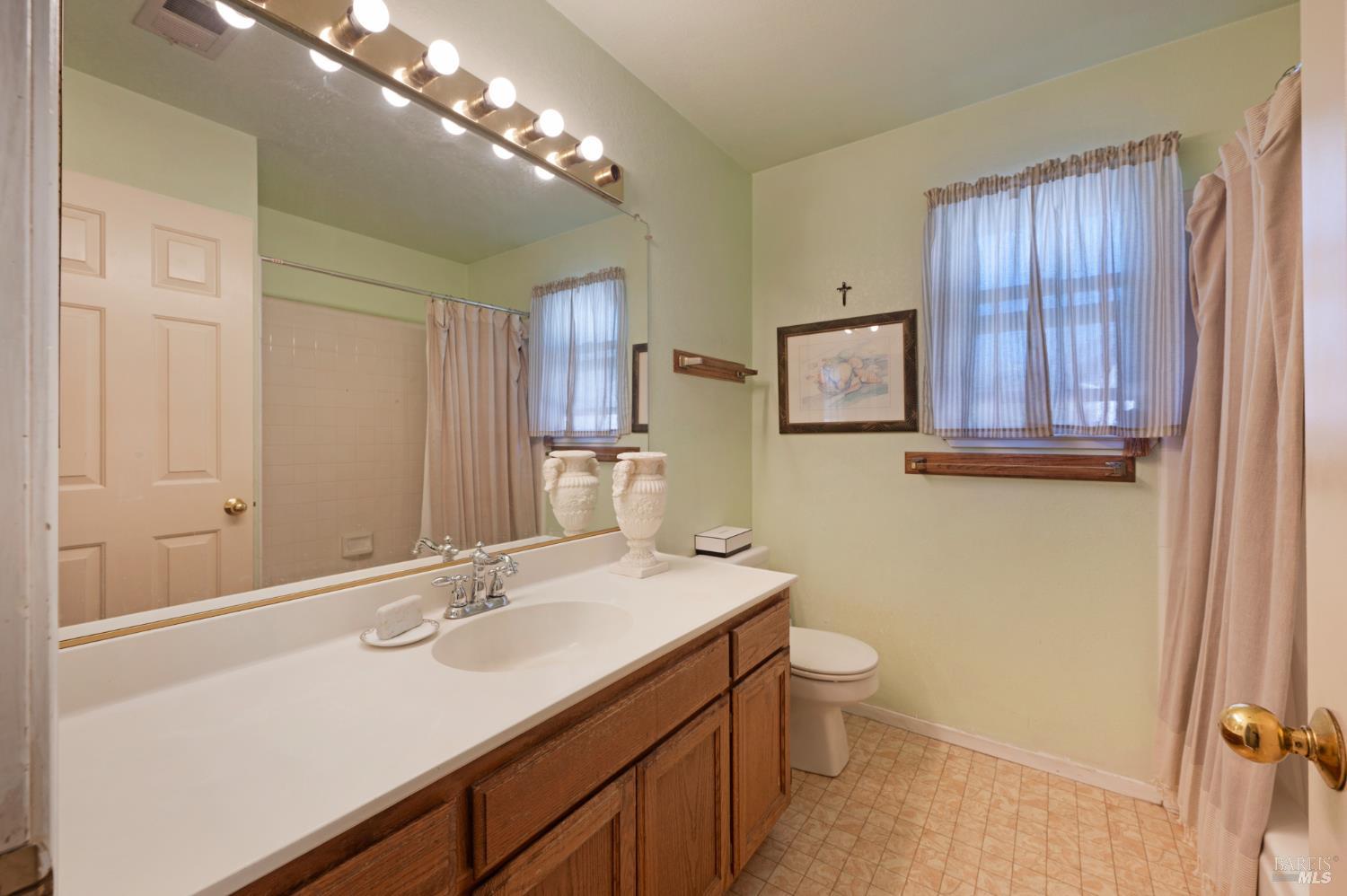 1905 Belair Way Santa Rosa, CA 95403 - Photo 16 of 27 a bathroom with a sink a toilet and mirror
