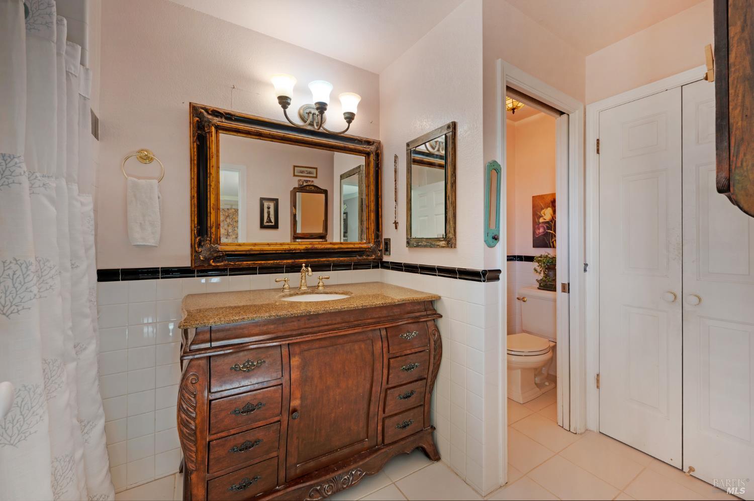 1905 Belair Way Santa Rosa, CA 95403 - Photo 20 of 27 a bathroom with a granite countertop sink vanity and a mirror