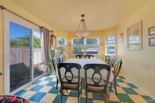 a dining room with furniture wooden floor and a rug