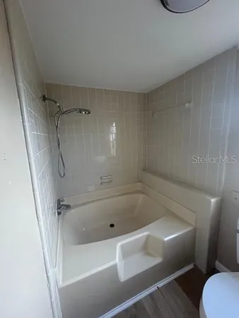a bathroom with a tub and a shower