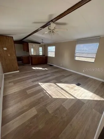 a view of a big room with closet and windows