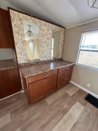 a kitchen with stainless steel appliances granite countertop a sink and a granite counter tops with a large window