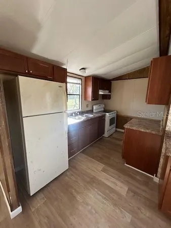 a kitchen with stainless steel appliances granite countertop a refrigerator stove a sink and dishwasher